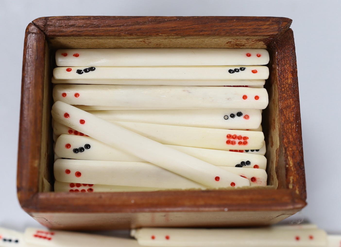 An early 20th century Chinese bone and bamboo mah jong set in two hardwood slide top boxes, largest 26.5cms wide x 5cms high